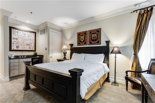 bedroom featuring baseboards, visible vents, crown molding, and light colored carpet