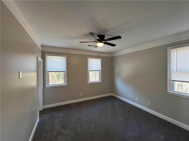 carpeted empty room with ceiling fan, a healthy amount of sunlight, and ornamental molding