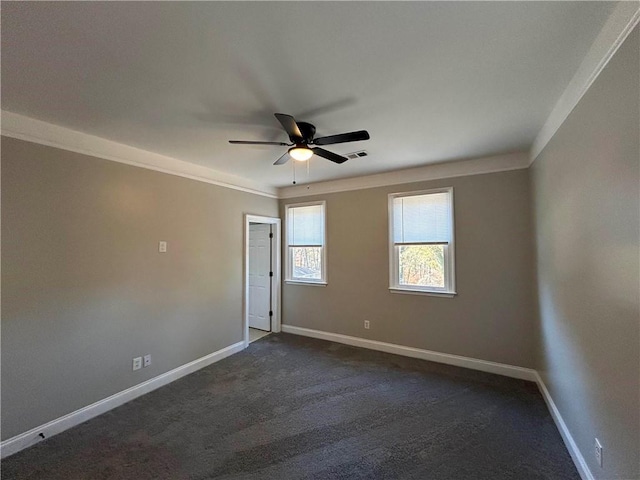 carpeted spare room featuring ceiling fan and ornamental molding