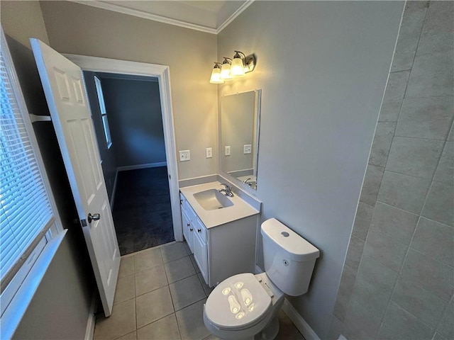 bathroom with tile patterned floors, crown molding, vanity, and toilet