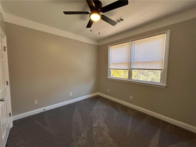 carpeted spare room with ceiling fan and crown molding