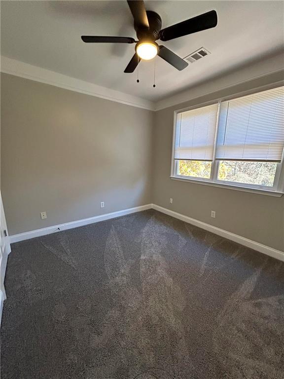 spare room with carpet flooring, ceiling fan, and ornamental molding