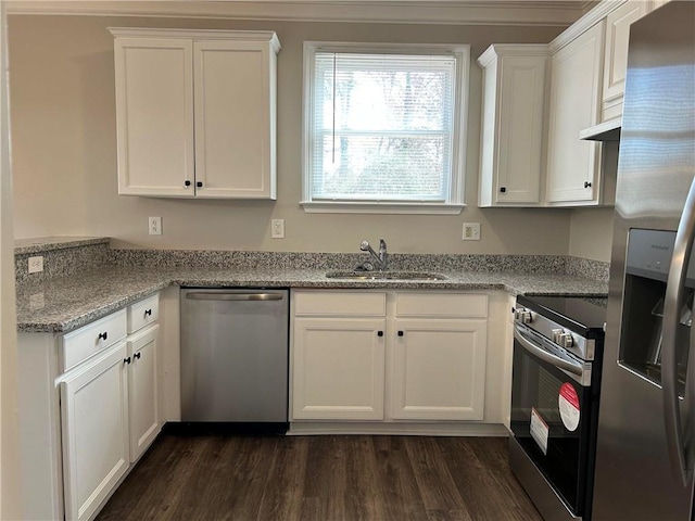 kitchen featuring appliances with stainless steel finishes, dark hardwood / wood-style flooring, light stone counters, sink, and white cabinets