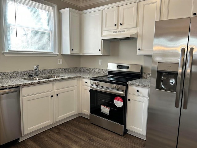 kitchen with white cabinets, stainless steel appliances, light stone counters, and sink