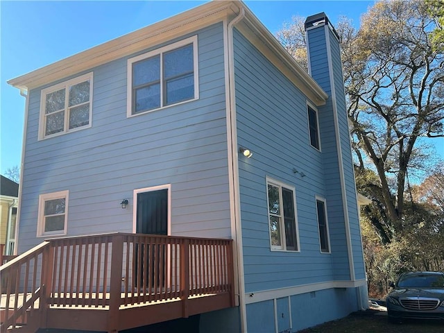 back of house with a wooden deck