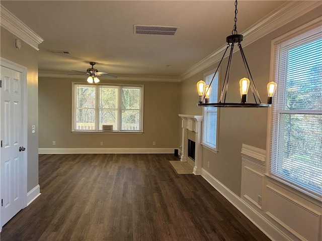 unfurnished living room with ceiling fan with notable chandelier, dark hardwood / wood-style flooring, and crown molding