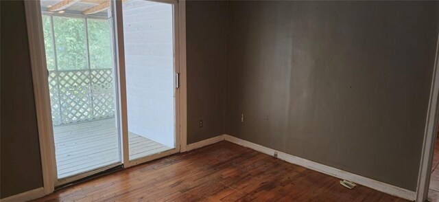 unfurnished room with hardwood / wood-style flooring