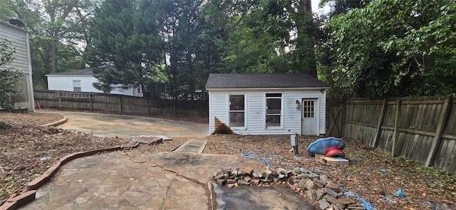 view of yard featuring an outdoor structure and a patio