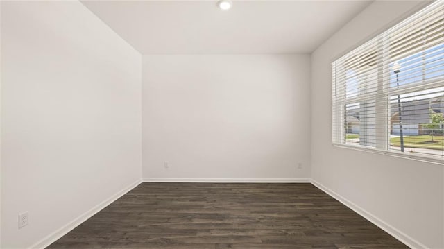 spare room with dark hardwood / wood-style floors