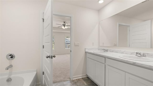 bathroom with vanity and a bath