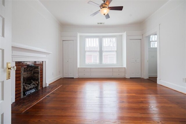 unfurnished living room featuring visible vents, a ceiling fan, hardwood / wood-style floors, and a fireplace