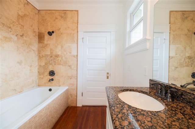 full bath featuring wood finished floors, vanity, and ornamental molding