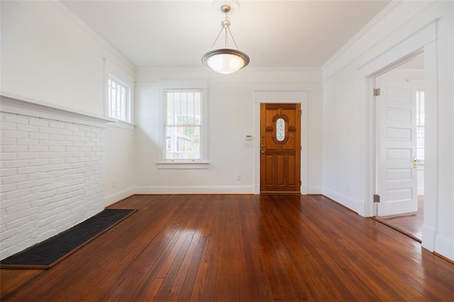 entryway with crown molding, baseboards, and wood-type flooring