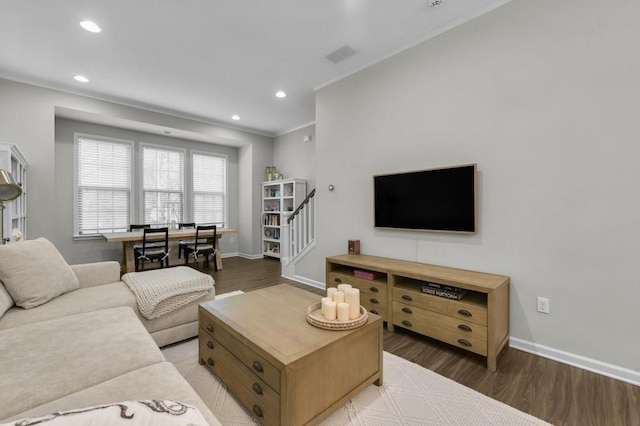 living room with hardwood / wood-style flooring and ornamental molding