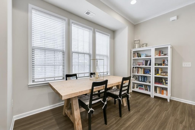 dining space with crown molding, dark hardwood / wood-style floors, and a wealth of natural light