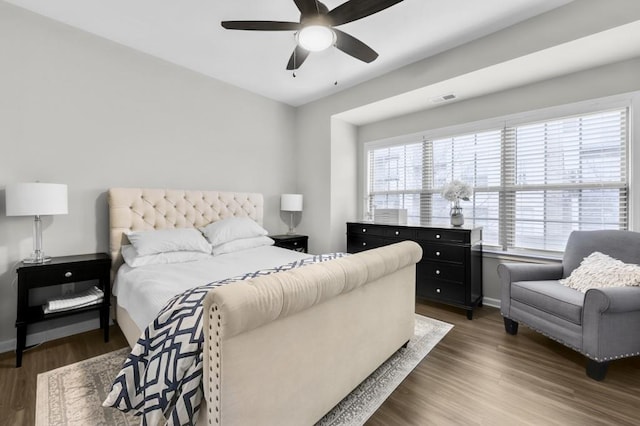 bedroom featuring dark hardwood / wood-style flooring and ceiling fan