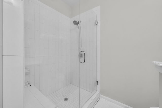 bathroom with walk in shower, toilet, and tile patterned flooring