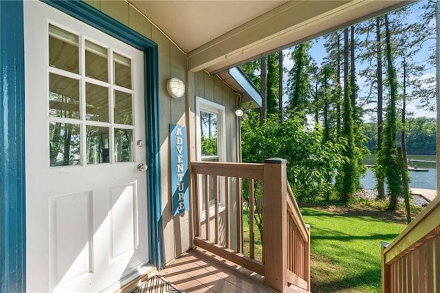 entrance to property featuring a yard and a water view