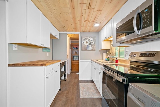 kitchen featuring stainless steel appliances, a sink, wood ceiling, dark wood-type flooring, and white cabinets