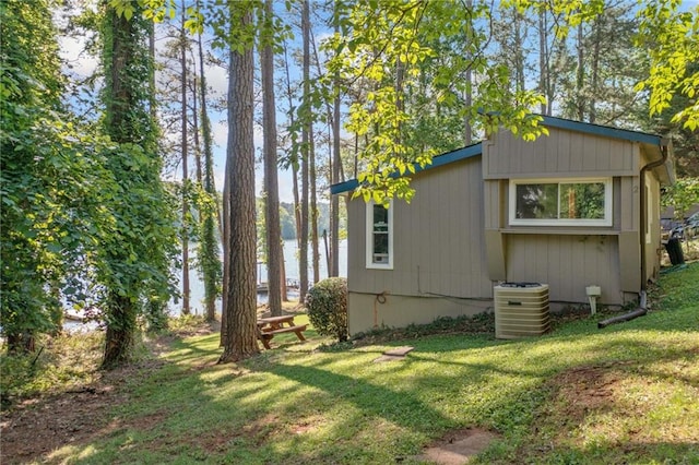 view of side of home with a yard and cooling unit