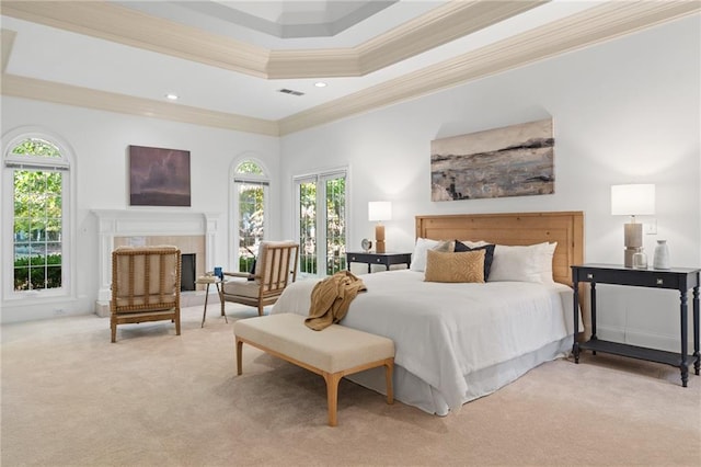 bedroom featuring light colored carpet, a raised ceiling, and ornamental molding