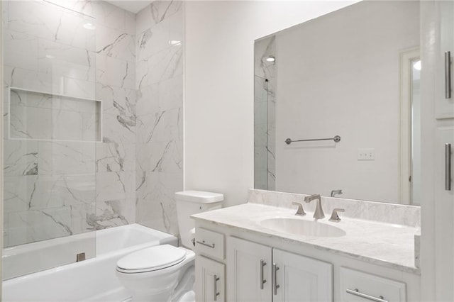 full bathroom with tiled shower / bath, toilet, and vanity