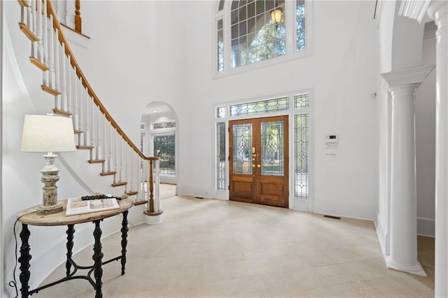 foyer entrance featuring a high ceiling and french doors