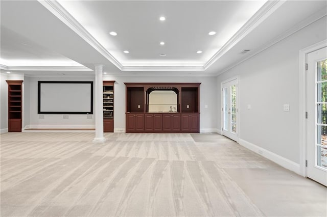 unfurnished living room with a wealth of natural light, light carpet, and decorative columns