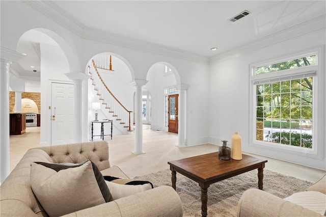 living room with ornate columns and crown molding