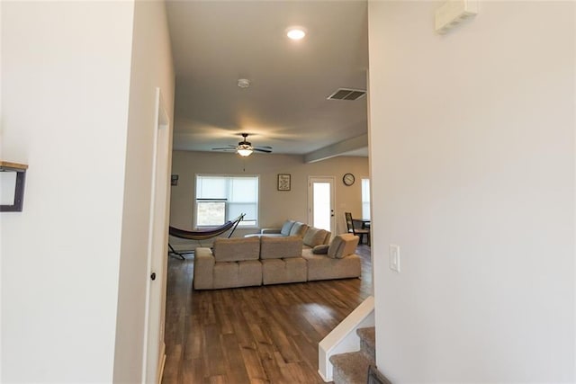 living area featuring dark wood-style flooring, recessed lighting, visible vents, a ceiling fan, and stairs