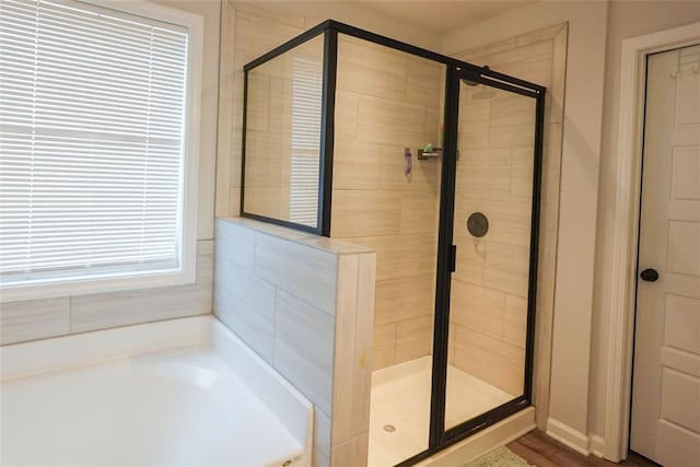 full bathroom with a stall shower and a garden tub