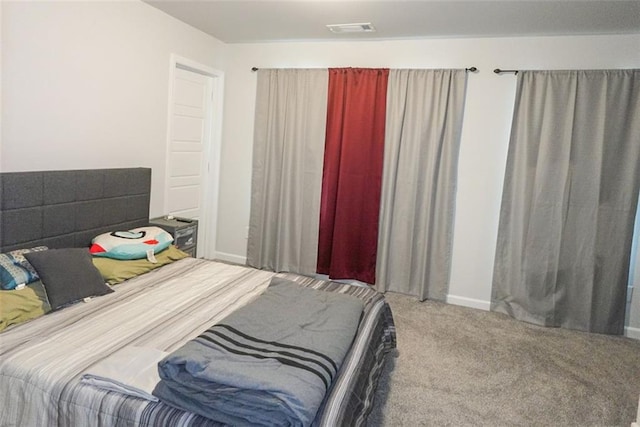 bedroom featuring baseboards, visible vents, and carpet flooring