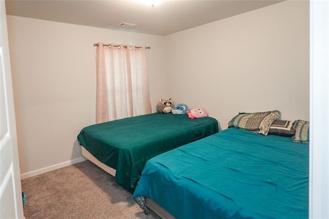 carpeted bedroom featuring baseboards and visible vents