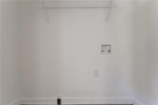 clothes washing area with hookup for a washing machine, laundry area, and baseboards