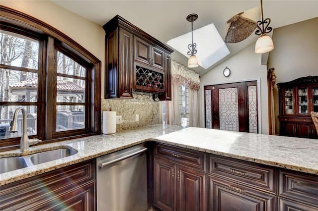 kitchen with dark brown cabinetry, decorative light fixtures, dishwasher, and a sink