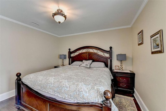 bedroom featuring crown molding, dark wood finished floors, and baseboards