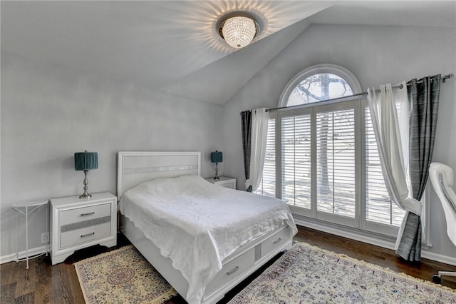 bedroom with multiple windows, vaulted ceiling, and dark wood finished floors