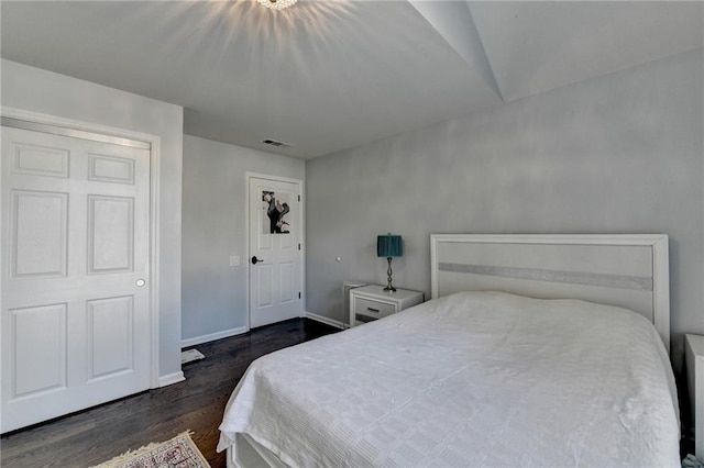 bedroom featuring visible vents, baseboards, and dark wood-type flooring