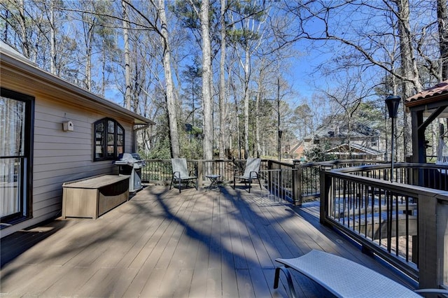 wooden terrace featuring area for grilling