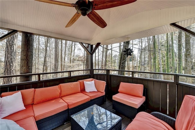 sunroom featuring lofted ceiling and ceiling fan