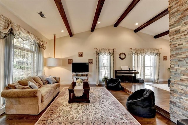 living room with baseboards, visible vents, dark wood finished floors, beamed ceiling, and high vaulted ceiling