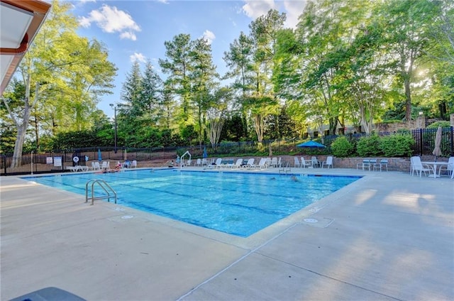 pool featuring a patio area and fence