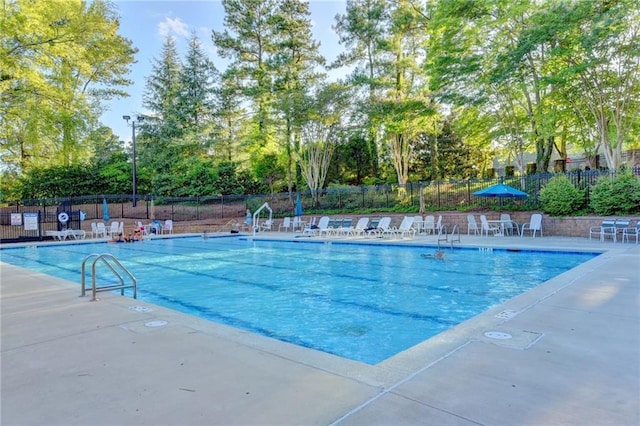 pool featuring a patio area and fence