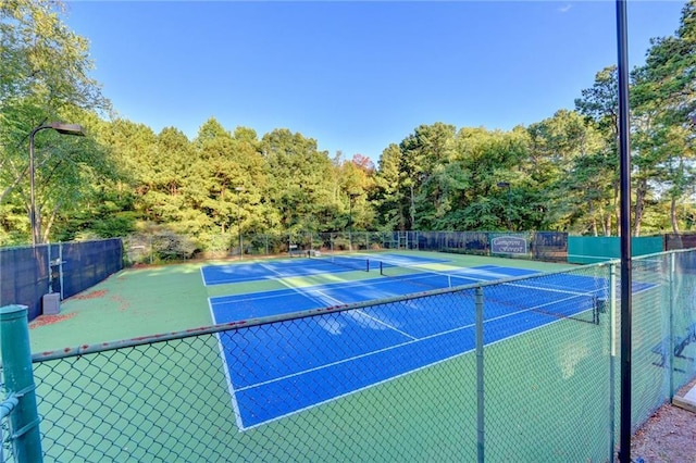 view of tennis court with fence