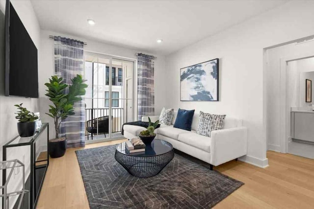 living area with recessed lighting, light wood finished floors, and baseboards