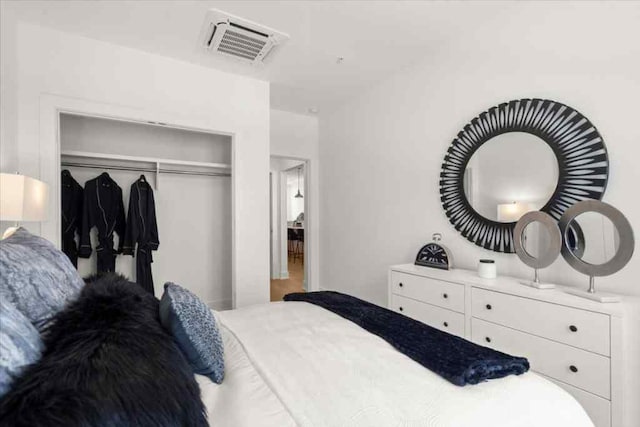 bedroom with a closet and visible vents