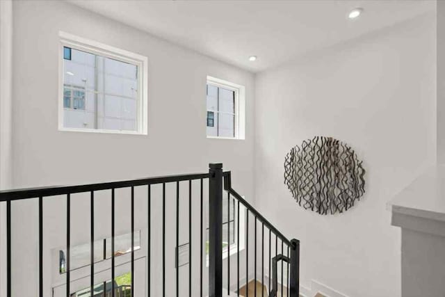 stairs featuring a healthy amount of sunlight and recessed lighting