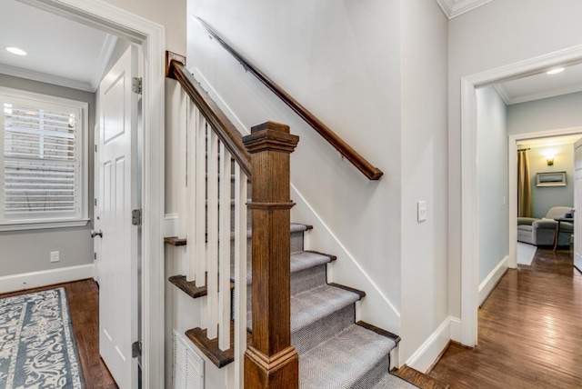 stairway featuring ornamental molding and hardwood / wood-style floors