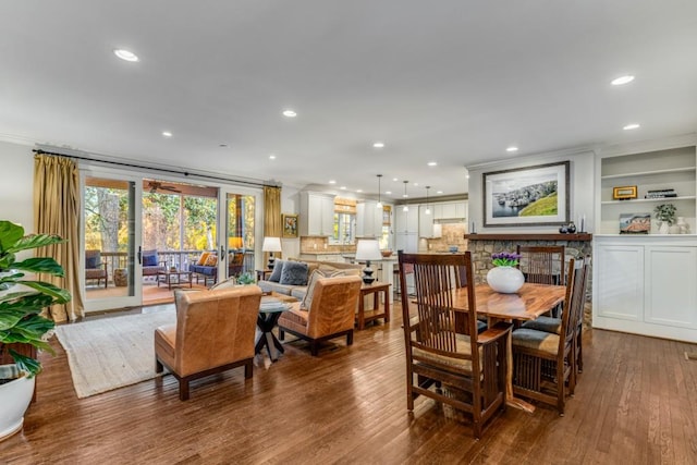 dining room with hardwood / wood-style flooring and crown molding