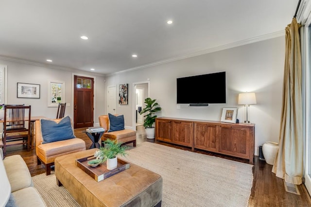 living room featuring dark wood-type flooring and ornamental molding